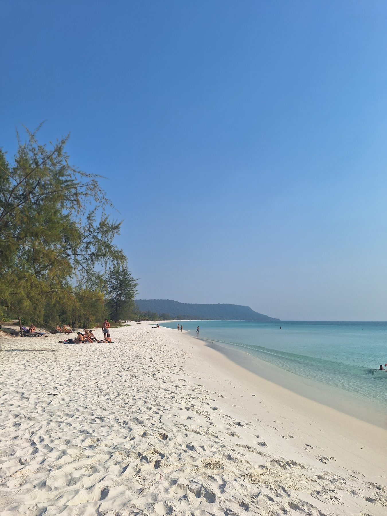 Empty white sand and turquoise shallows stretching into the distance on Koh Rong, Cambodia
