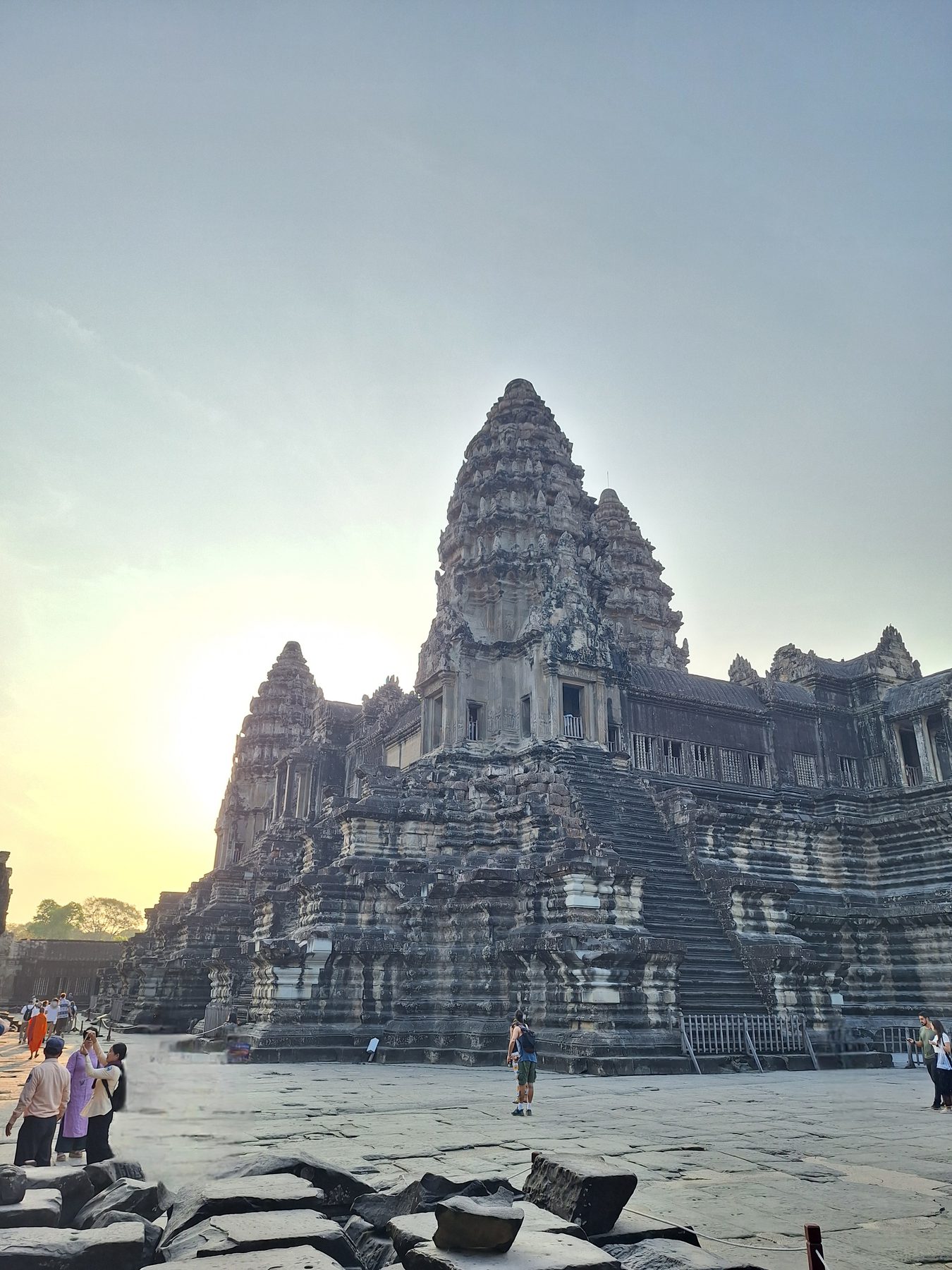 The central towers of Angkor Wat seen close up, with visitors on the steps below
