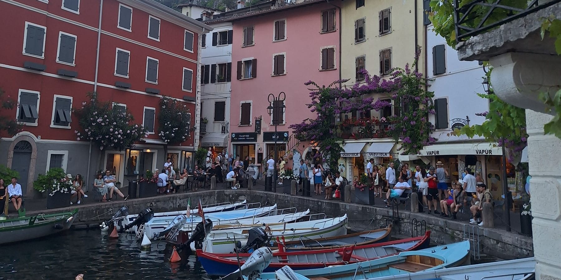 Painted houses and small boats around the old harbour at Limone sul Garda