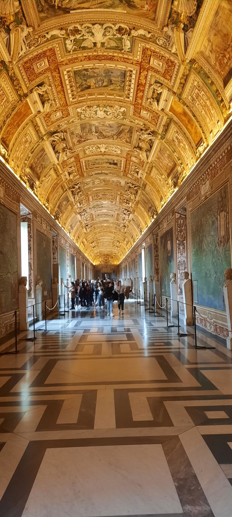 The long Gallery of Maps in the Vatican Museums, with a gilded, painted ceiling and polished marble floor