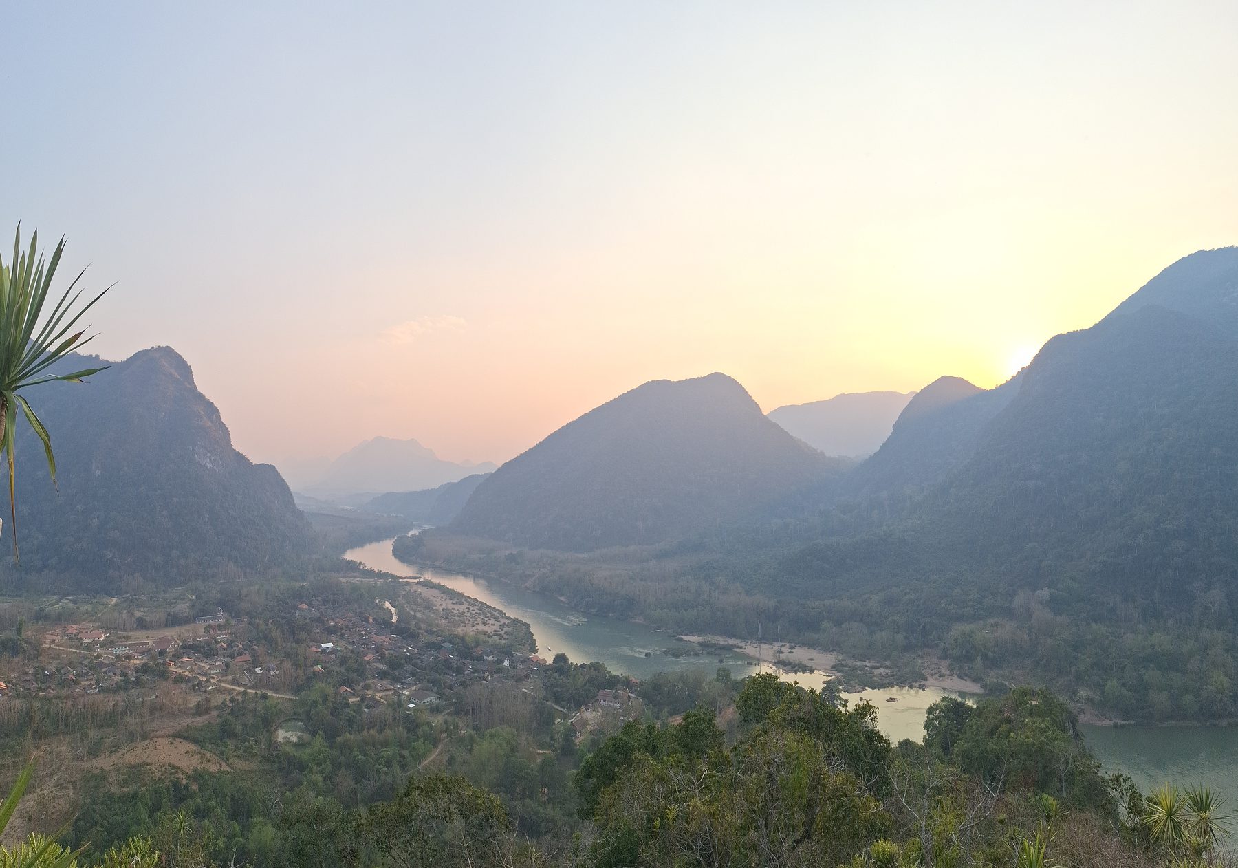 The Nam Ou river winding between mountains at sunset