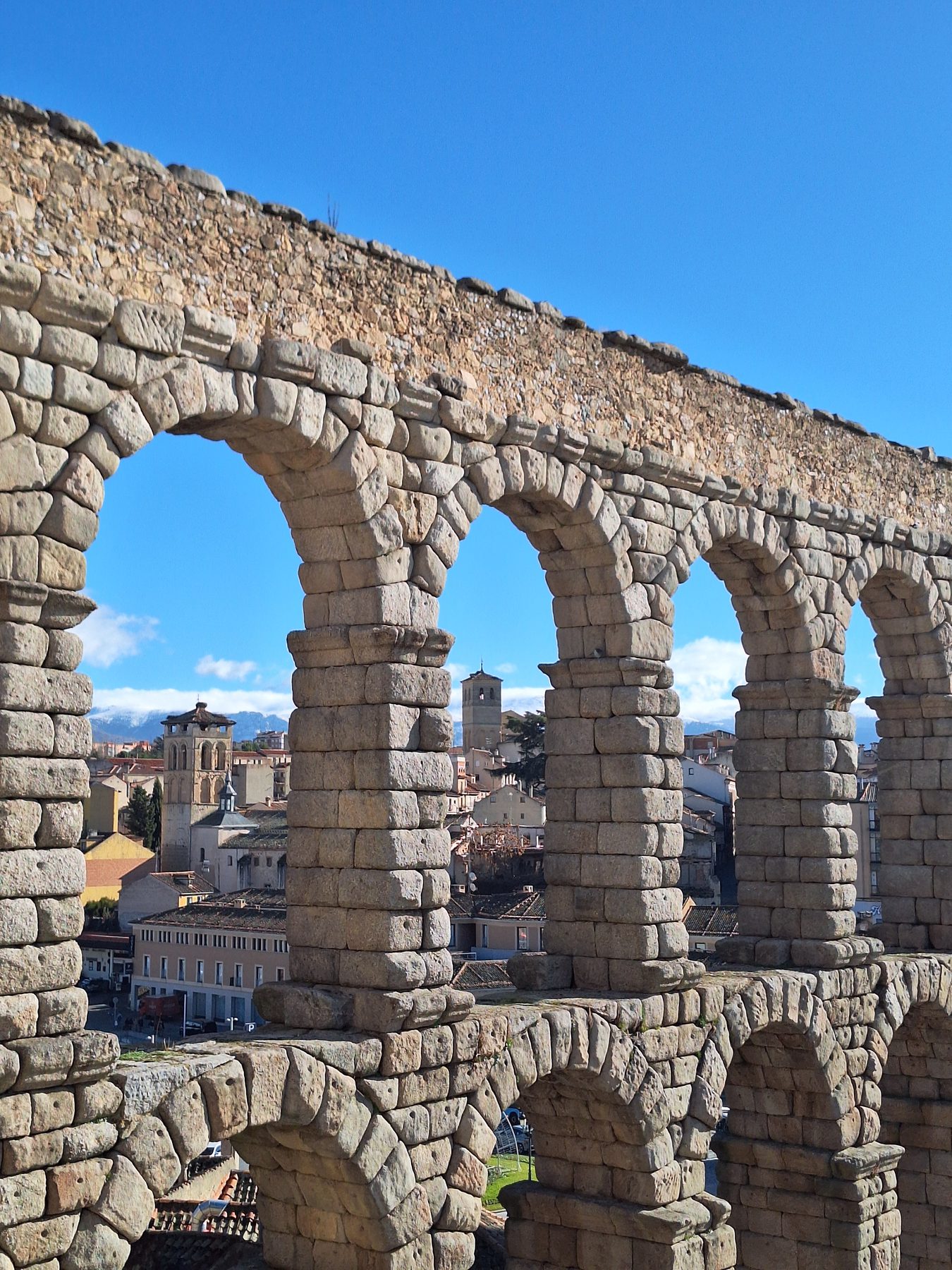 Looking through the arches of the Roman aqueduct at Segovia to the rooftops of the old town