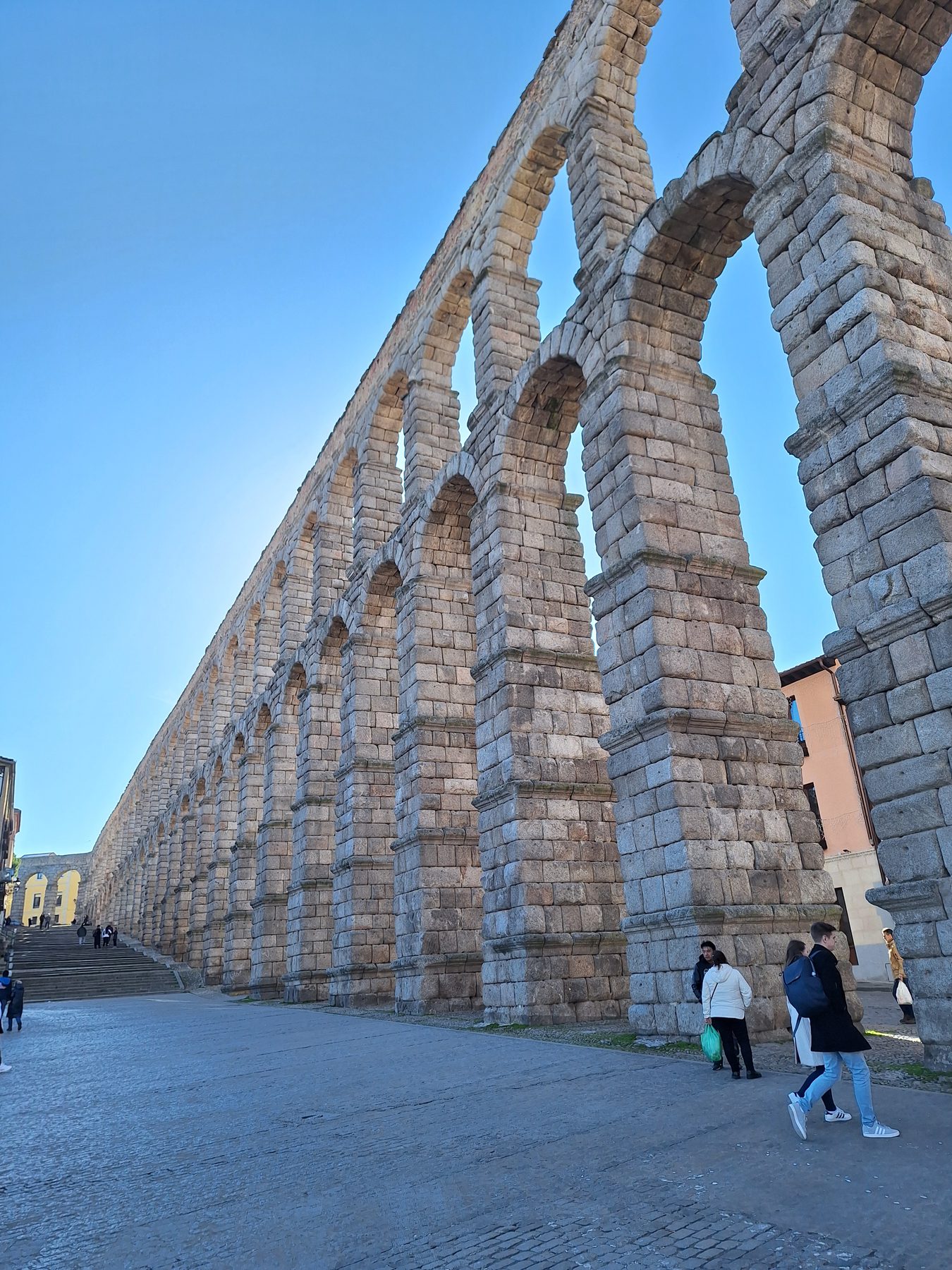 The tall double tier of arches of the Roman aqueduct at Segovia running through the city
