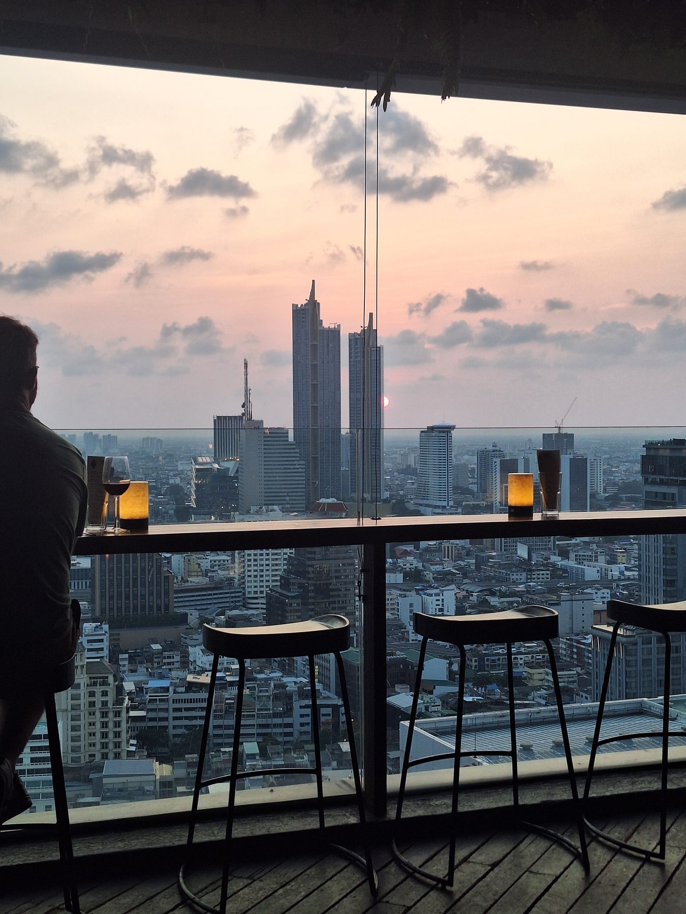 A rooftop bar looking over the Bangkok skyline at dusk, Thailand