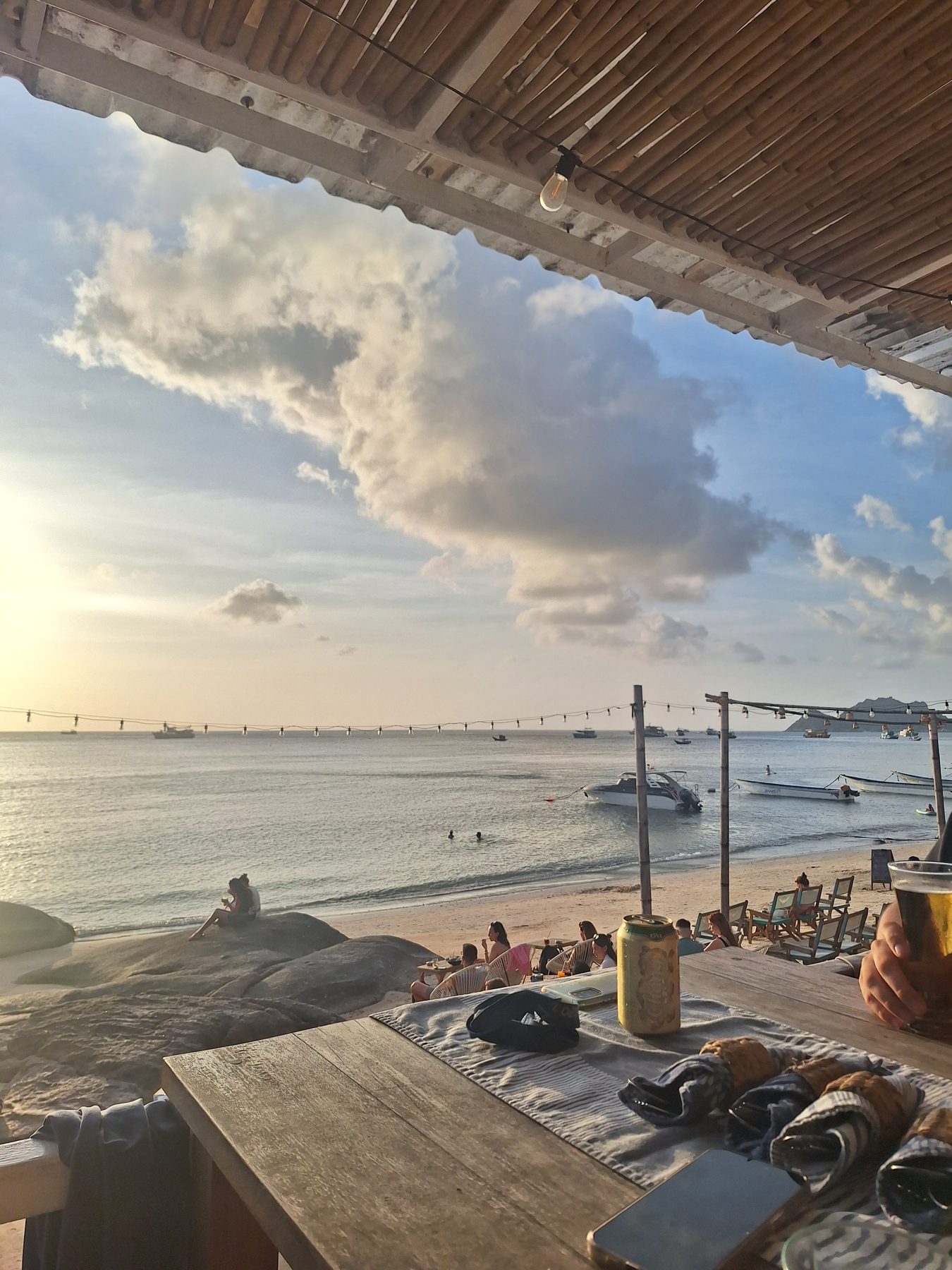 A beach bar looking out over the sea and moored boats on Koh Tao, Thailand