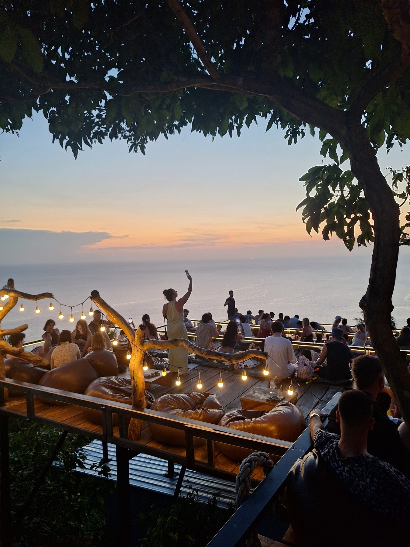 People watching the sunset from a beach bar on Koh Tao, Thailand