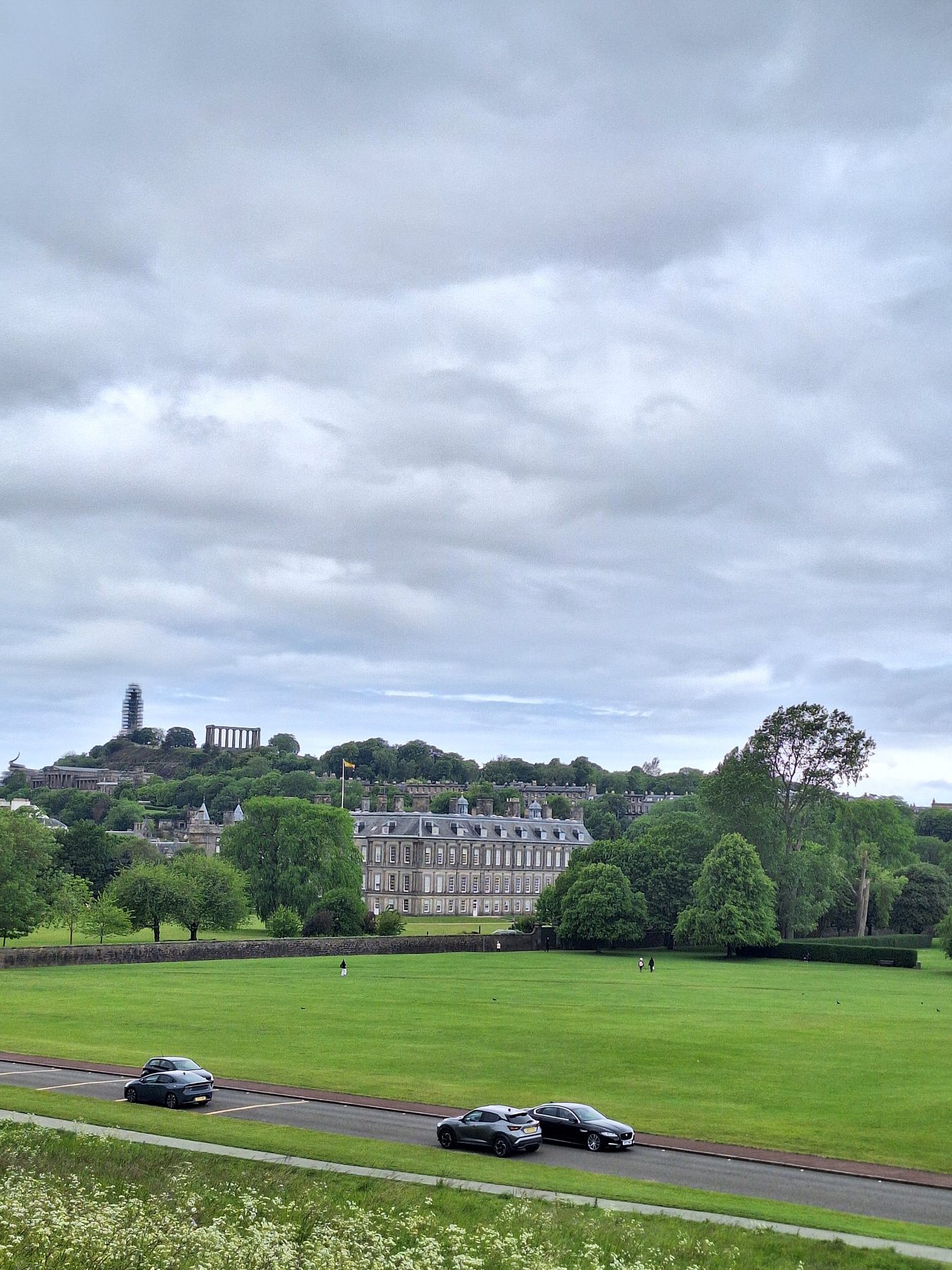 Open parkland below Calton Hill, with monuments standing on the skyline, Edinburgh