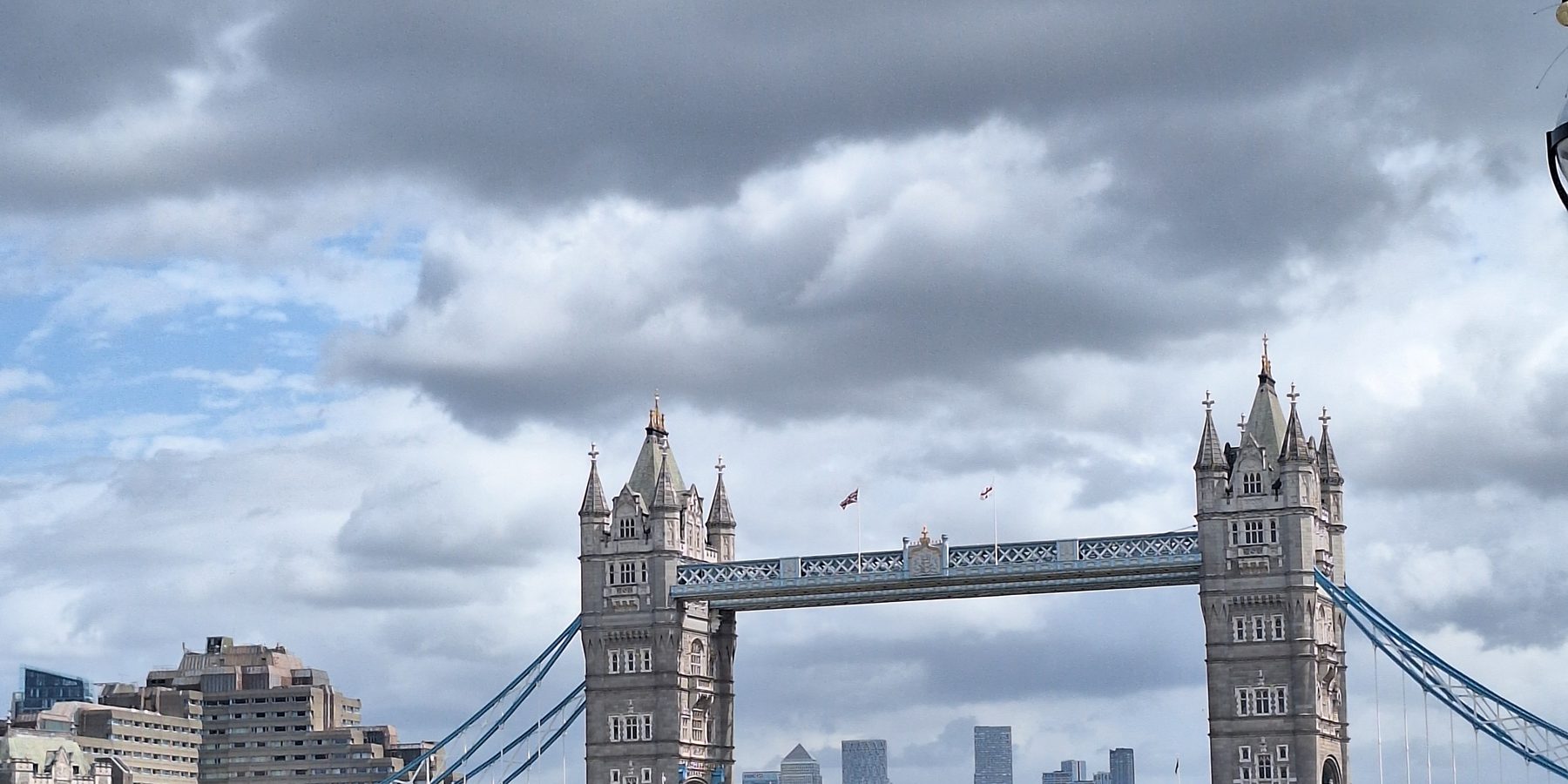 Tower Bridge over the Thames with the towers of Canary Wharf behind, London