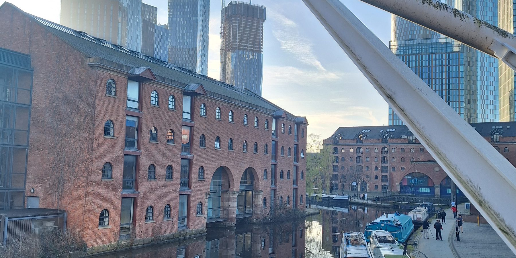 Brick canal warehouses reflected in the water at Castlefield, Manchester