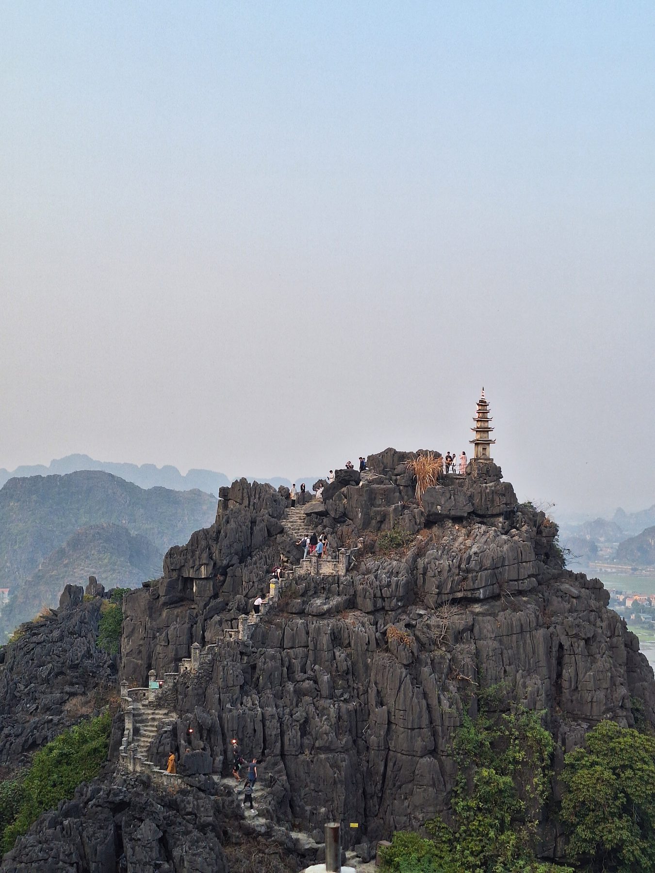 A temple on a rocky peak reached by steep steps at Hang Mua, Ninh Binh, Vietnam