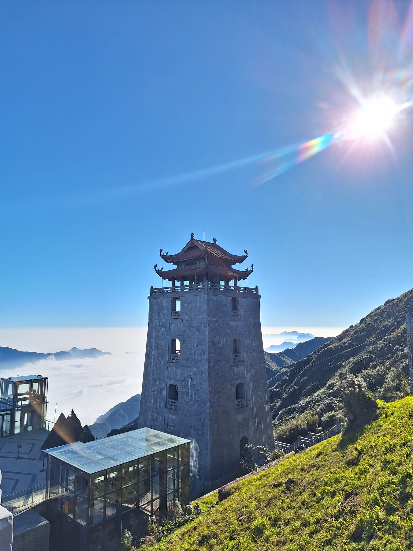 A stone tower on a ridge above a sea of cloud at Fansipan, Vietnam